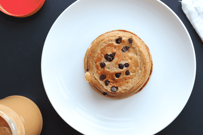 These healthy chocolate chip pancakes are so SIMPLE and DELICIOUS. Plus, the entire batch of pancakes has 27g of protein without any protein powder.