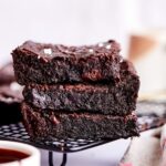 A stack of 3 brownies on a drying rack.