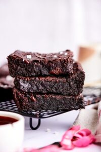 A stack of 3 brownies on a drying rack.