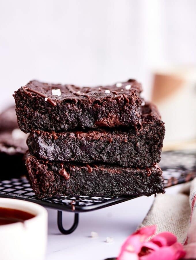 A stack of 3 brownies on a drying rack.