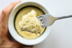 I'm obsessed with this easy vanilla mug cake recipe. It's low in carbs, flourless, packed with protein, and can be made with just a microwave! That's right there's no oven needed for this cake in a mug.