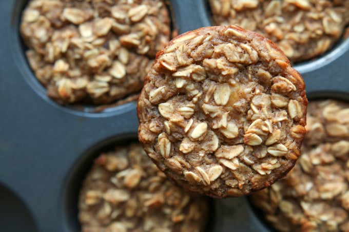 A banana oatmeal breakfast muffin on a muffin tin.