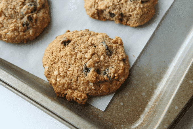 An oatmeal raisin cookie on a baking sheet