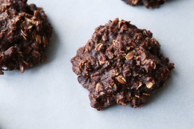 A chocolate and peanut butter oatmeal cookie on parchment paper