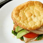 Carb free cloud bread being used as the bread for a turkey avocado and tomato sandwich.