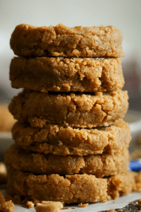 Keto peanut butter cookies stacked on top of each other.