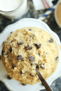 Chocolate chip cookie dough in a cup on a table.