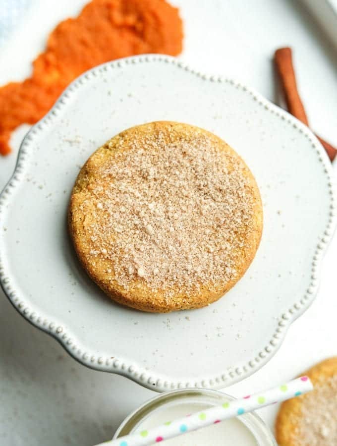 A pumpkin spice cookie resting on a serving plate.