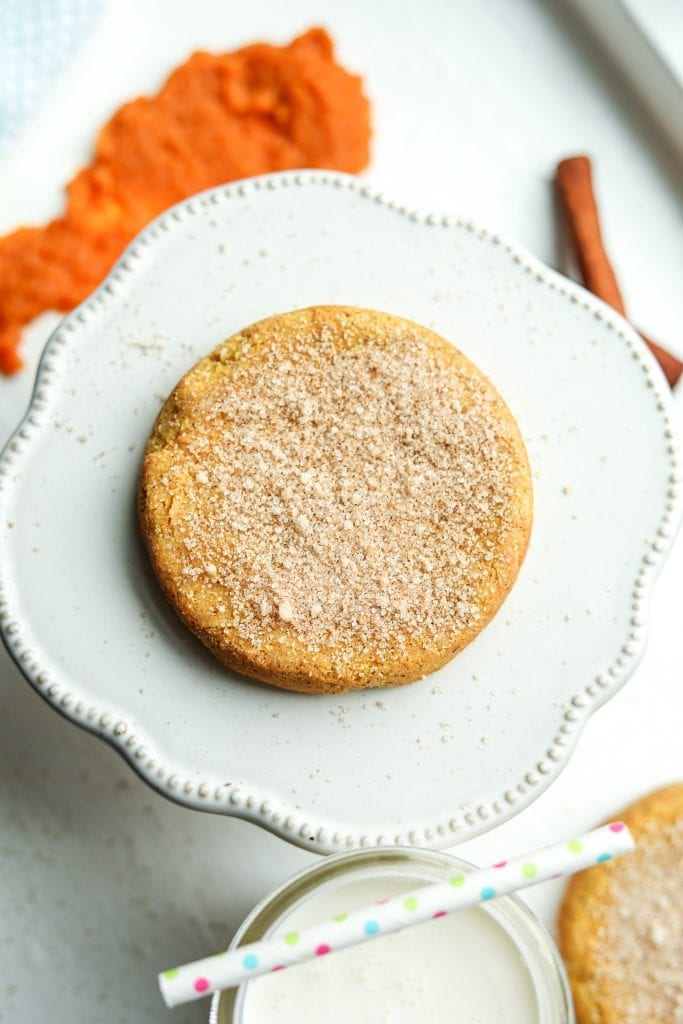 A pumpkin spice cookie resting on a serving plate.