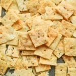 keto crackers seasoned with cool ranch laying on a baking sheet.