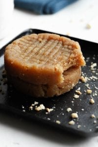 Cookies stacked on each other with a bite taken out of one.