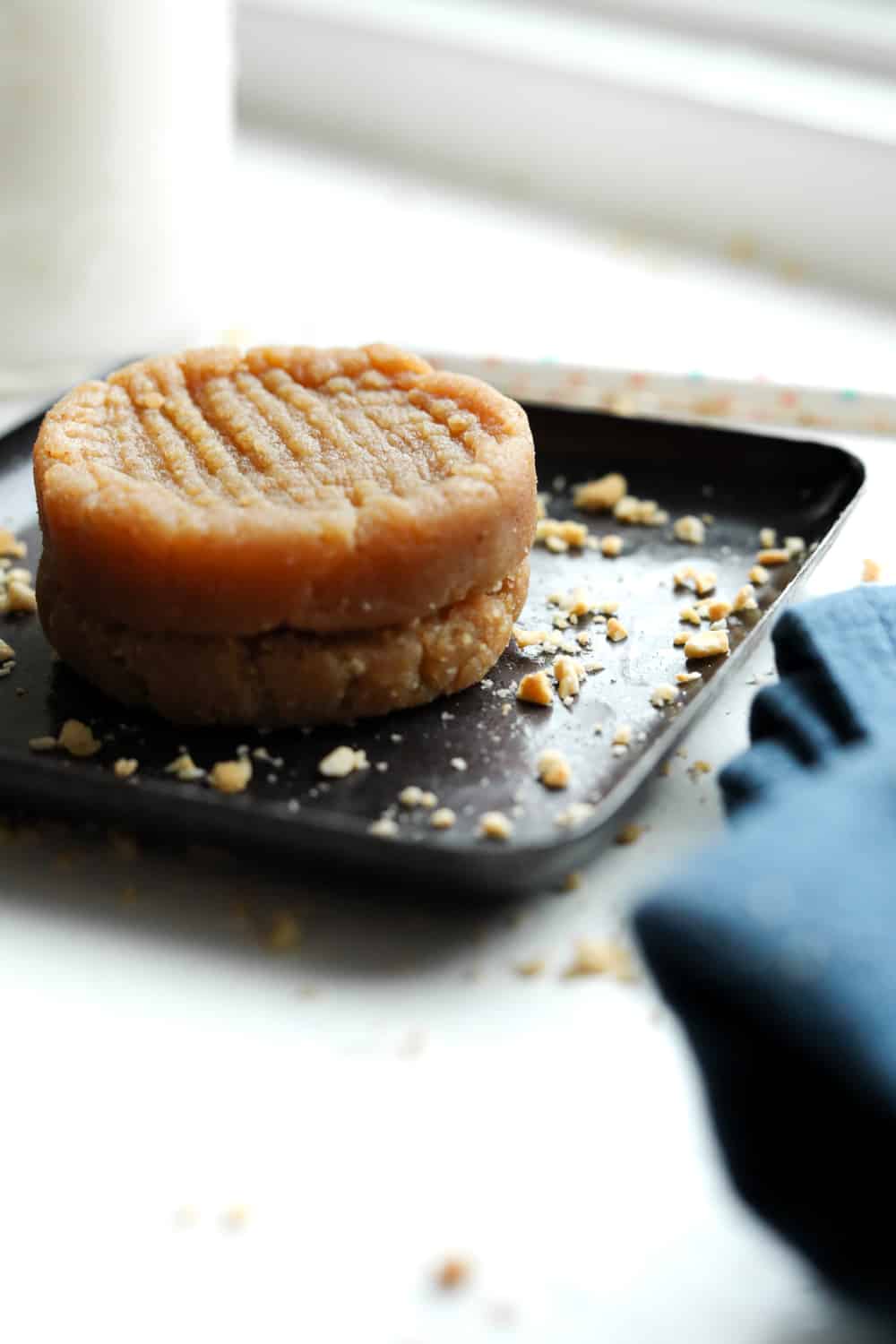 Cookies stacked on top of each other sitting on a plate.