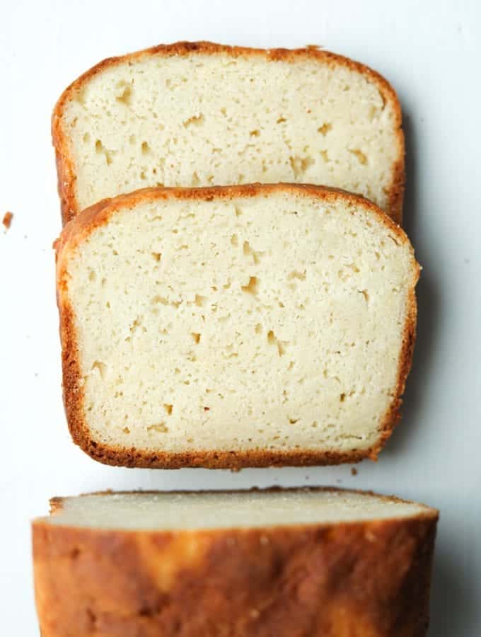 A loaf of bread cut into 2 slices that are laying on top of each other