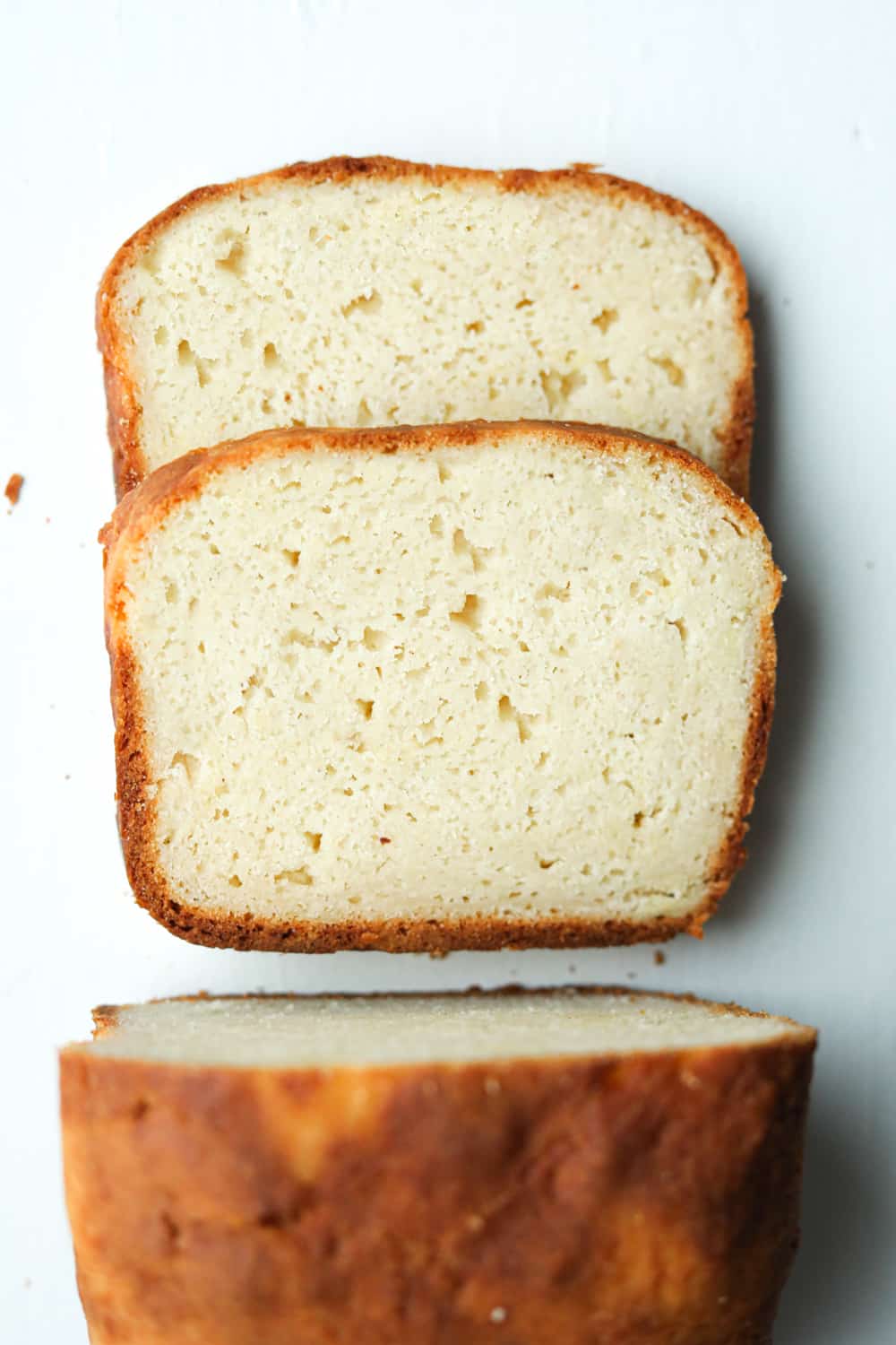 A loaf of bread cut into 2 slices that are laying on top of each other