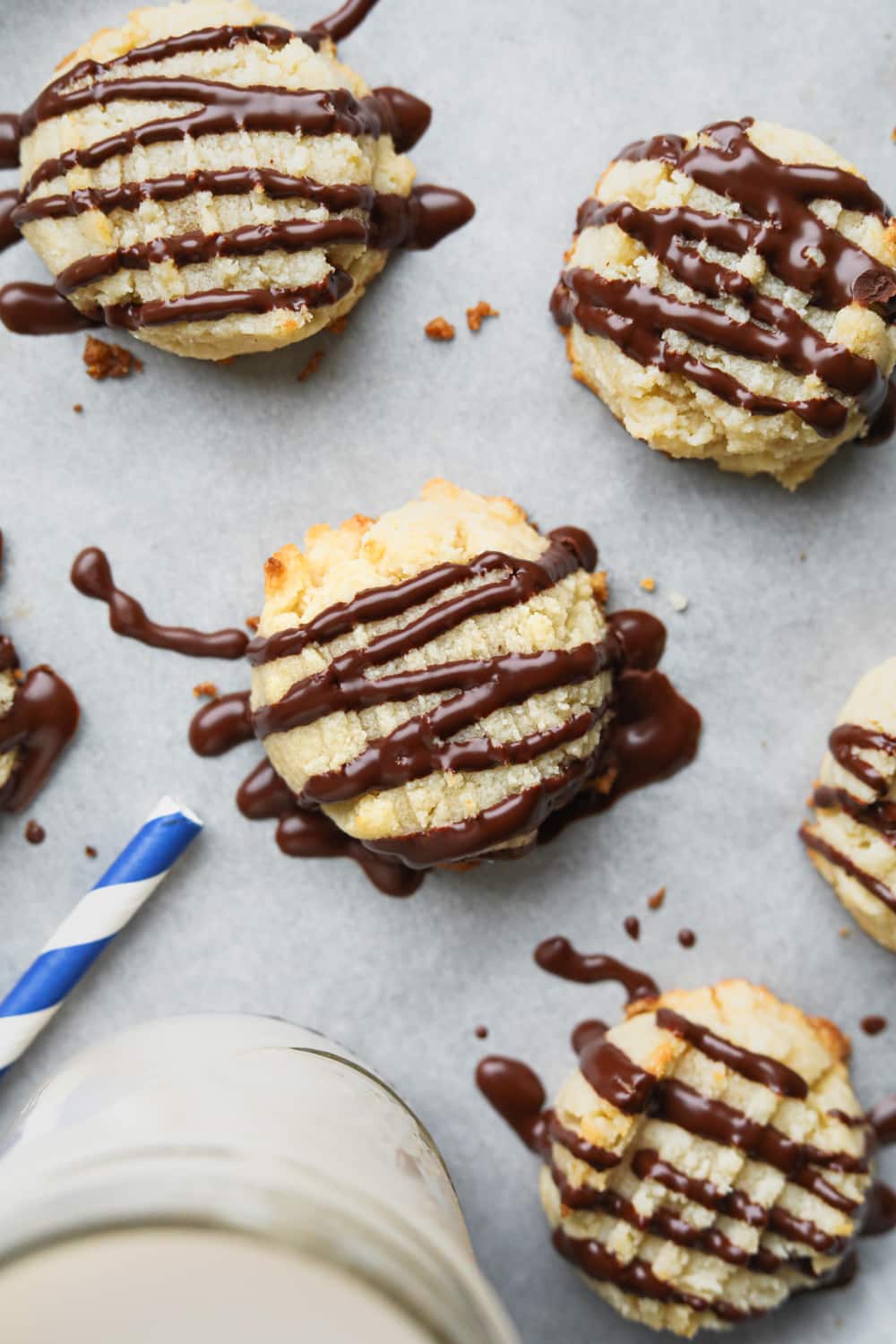 Keto butter cookies laying next to a glass of milk.