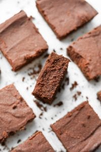 Brownies on a plate with the middle on inverted to show how fudgy it is.