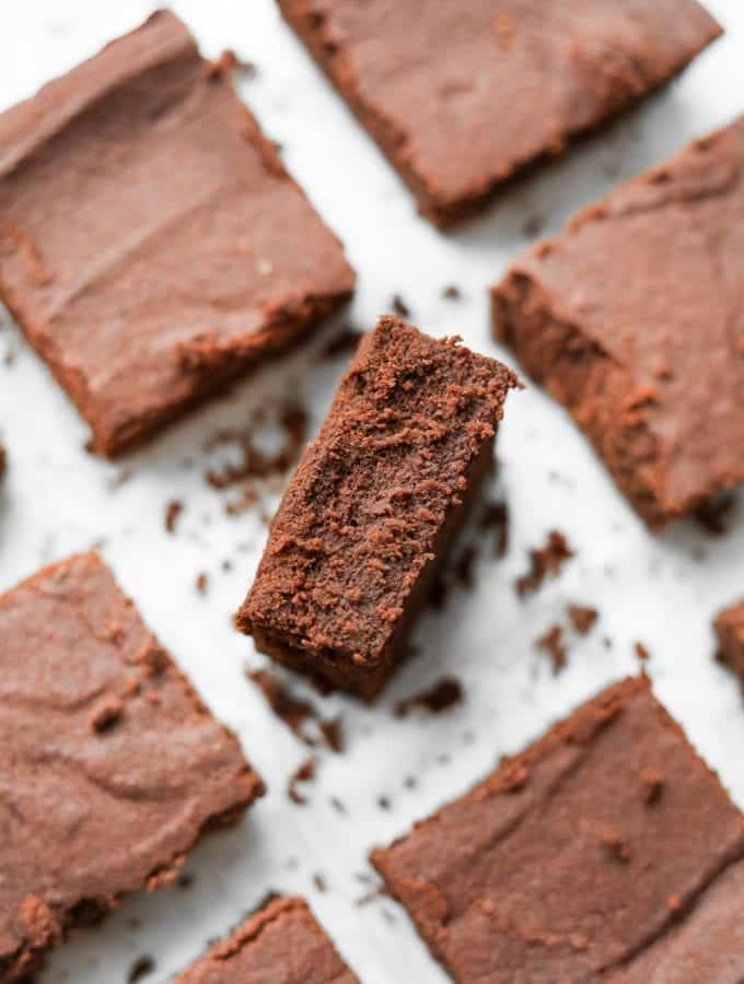 Brownies on a plate with the middle on inverted to show how fudgy it is.