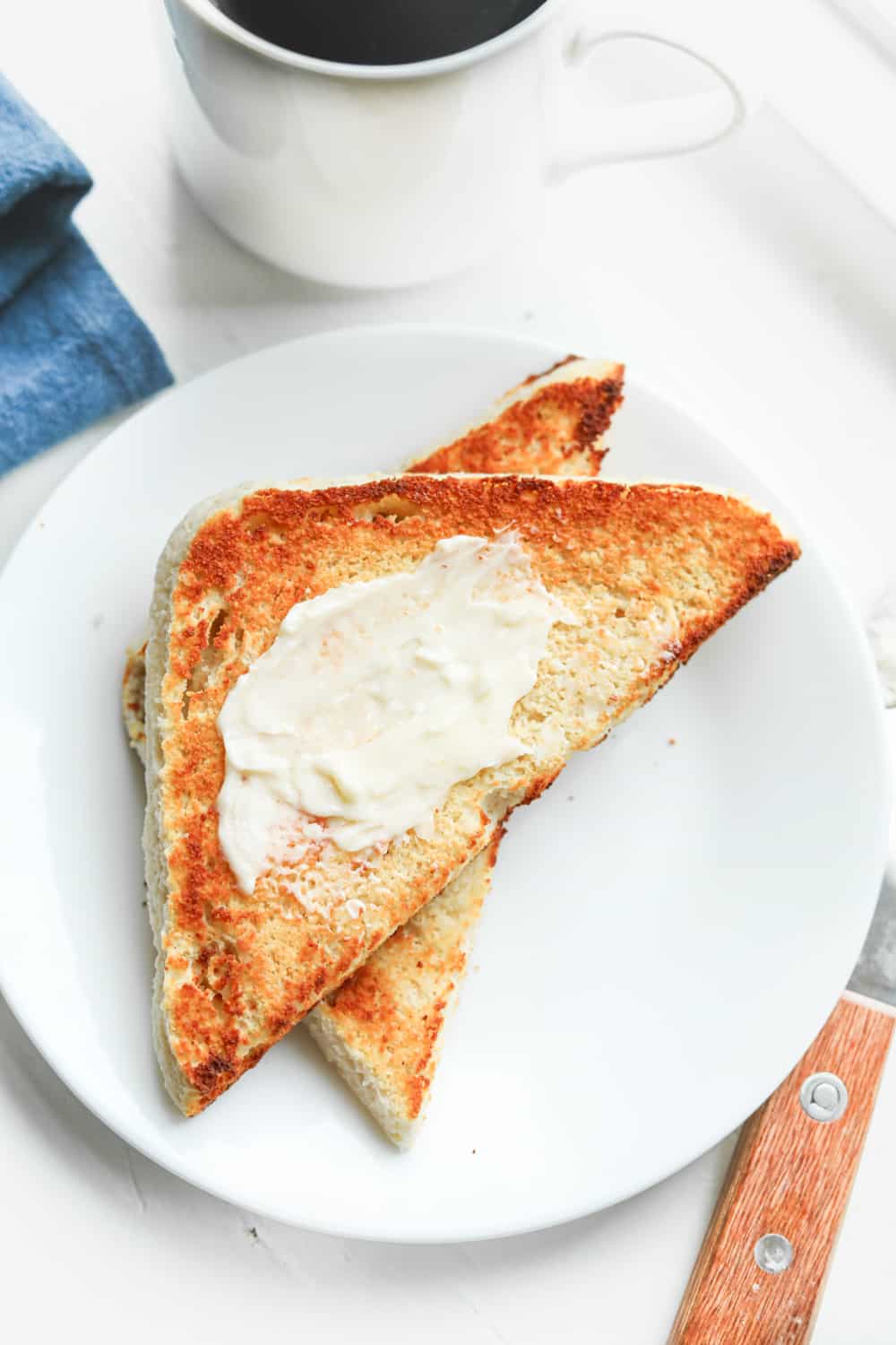 Keto toast on a plate with butter on it