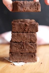 A fudgy brownie being held in a hand.