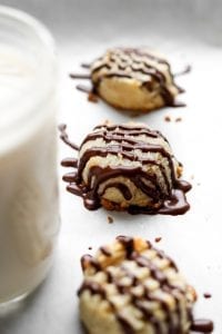 3 Butter cookies drizzled with chocolate laying next