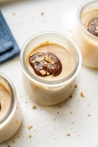 3 Jars of low carb peanut butter mousse covered with chocolate and peanuts.