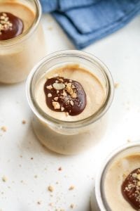 Peanut butter mousse covered in a chocolate drizzle and peanuts.