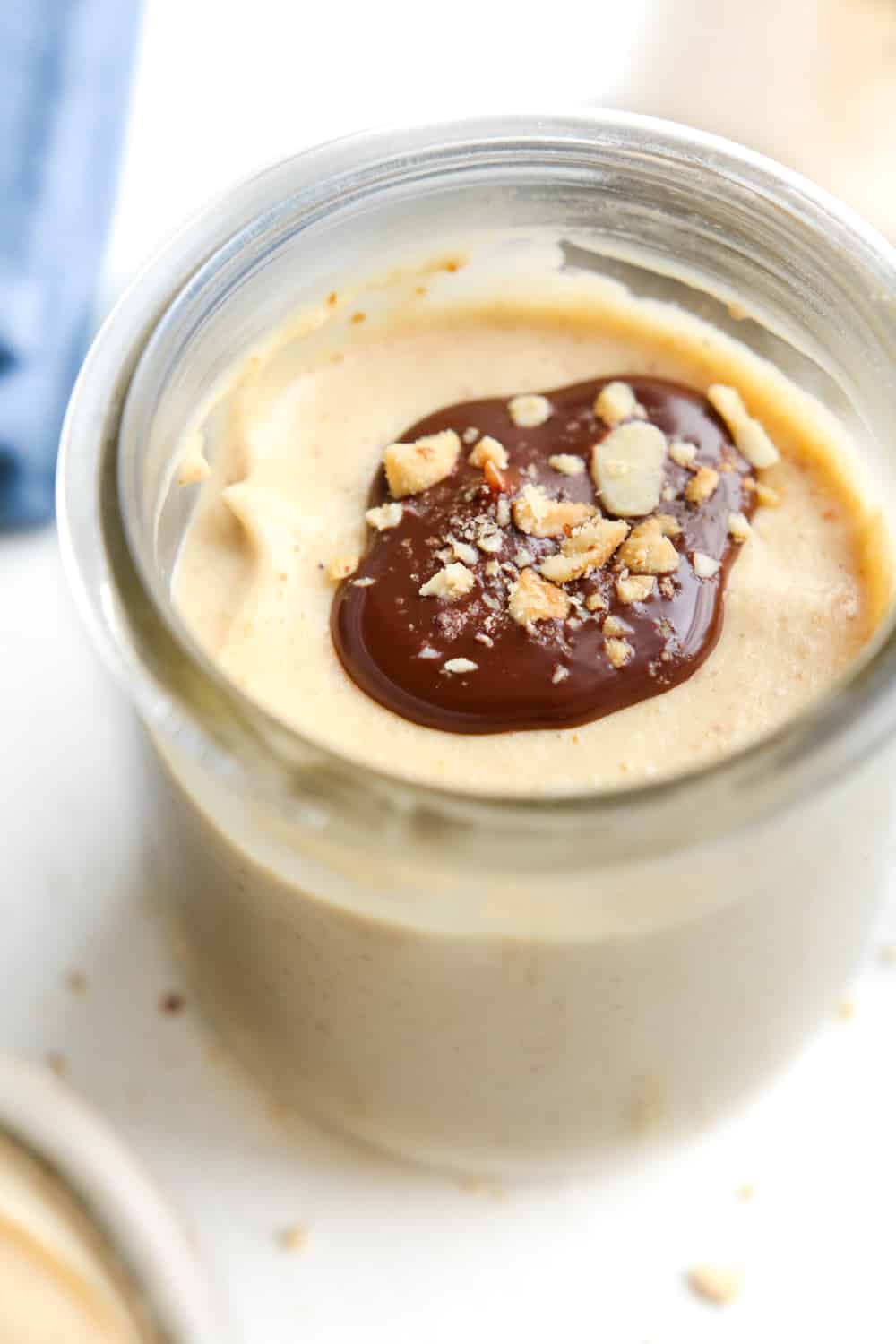 Peanut butter keto mousse topped with chocolate and peanuts.