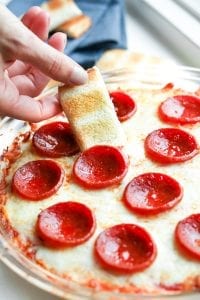 Low carb bread about to be dipped into pizza dip