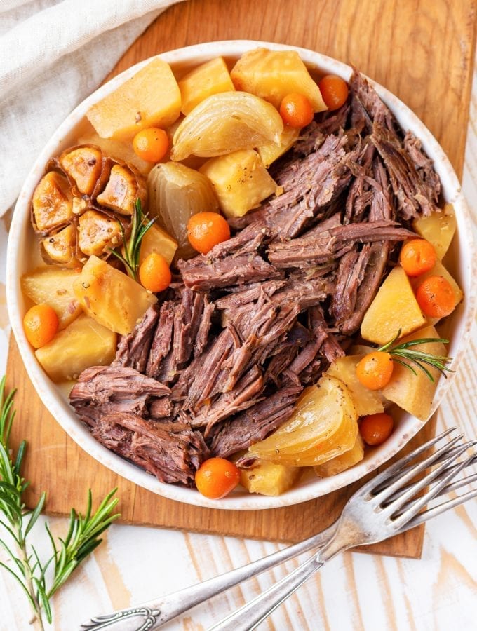 Keto pot roast on a serving platter next to a fork.