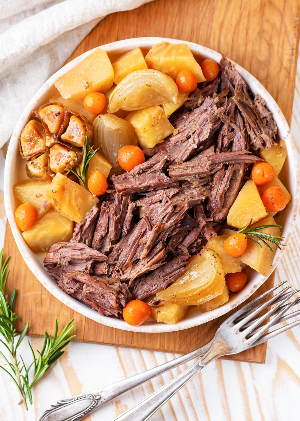 Keto pot roast on a serving platter next to a fork.