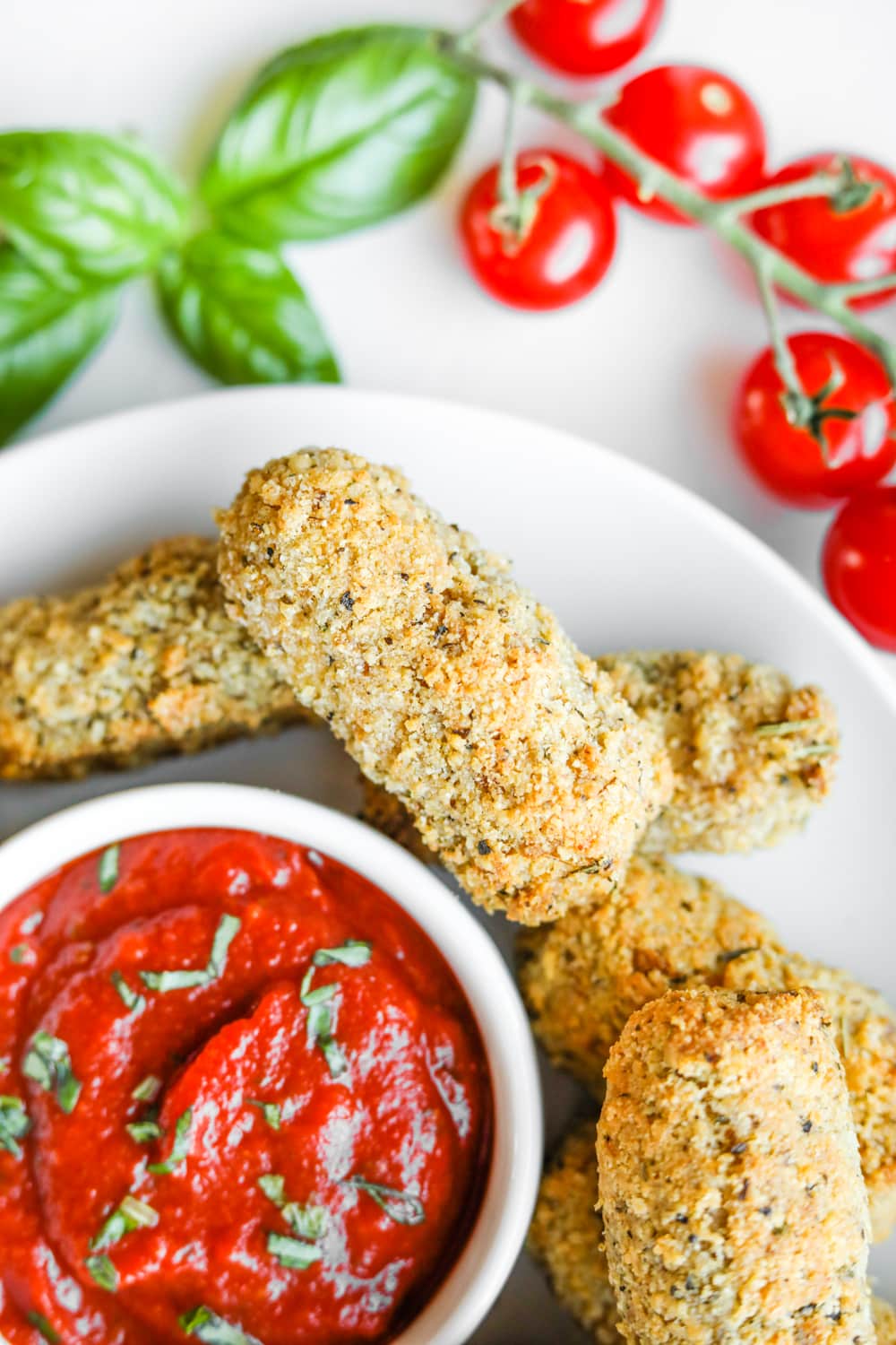 A pile of low carb cheese sticks on a plate.