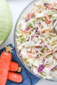 Keto coleslaw with cabbage and carrots next to it.