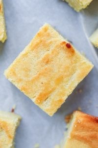 One slice of low carb cornbread on parchment paper.