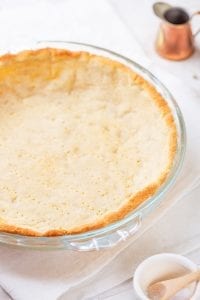 A keto pie crust in a pie plate.