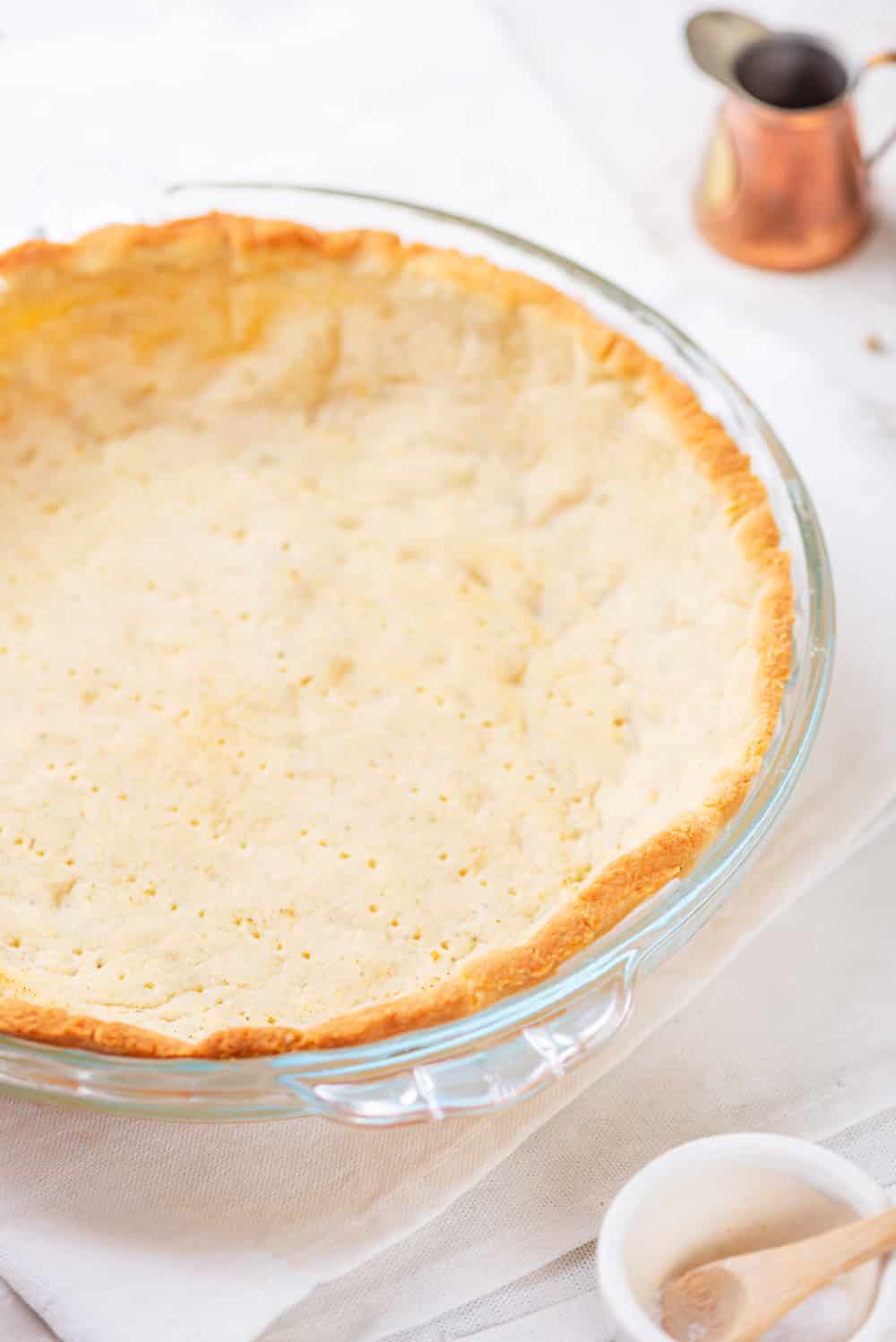 A keto pie crust in a pie plate.