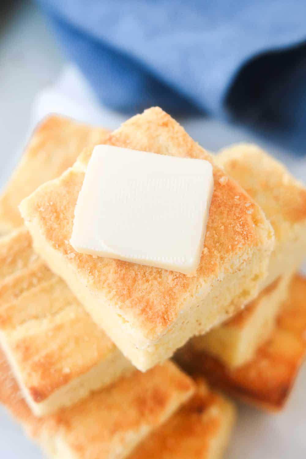 Slices of cornbread stacked on top of one another.