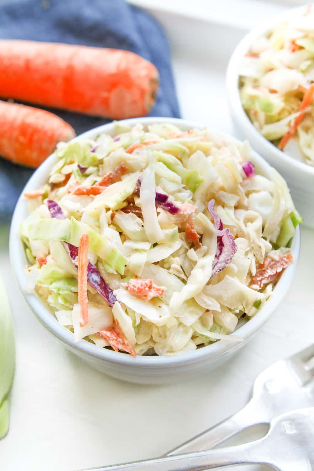A bowl of coleslaw for the keto diet, with another bowl positioned behind it.