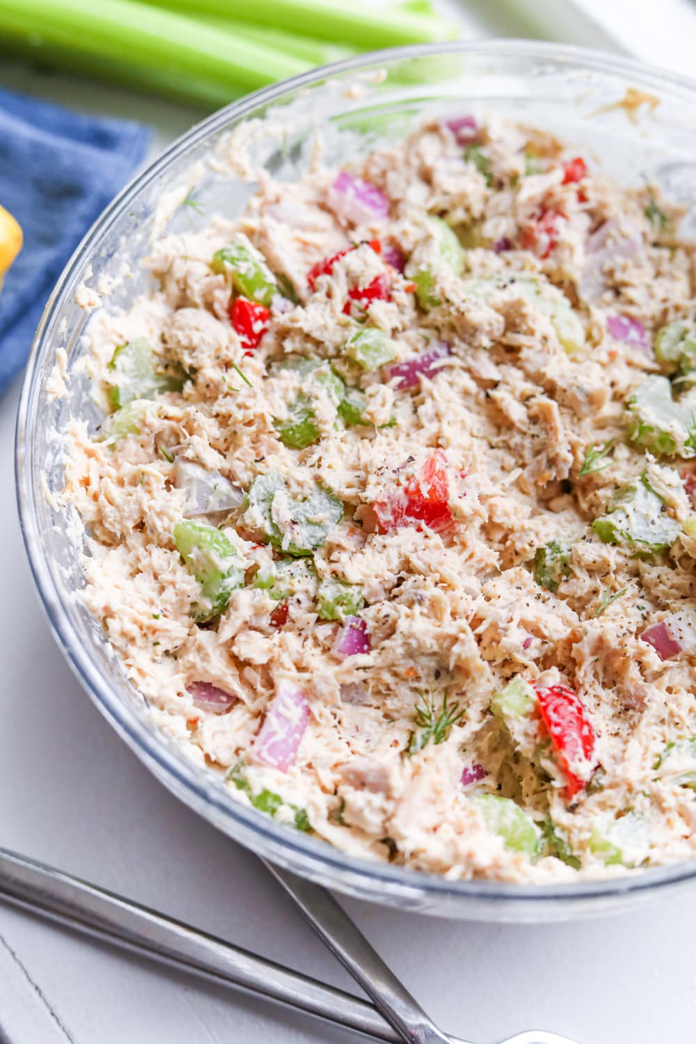 Tuna salad in a bowl with celery next to it.