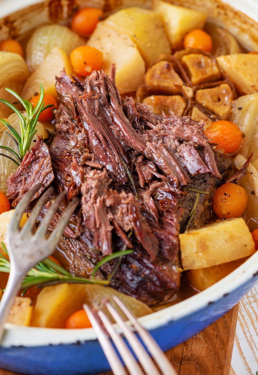 A keto pot roast being shredded by a fork.