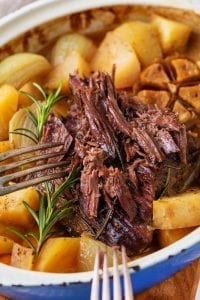 Shredded pot roast in a Dutch oven.