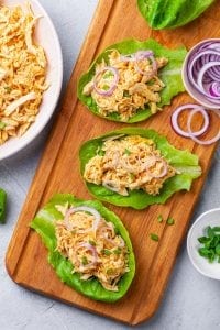 Buffalo chicken lettuce wraps on a cutting board.