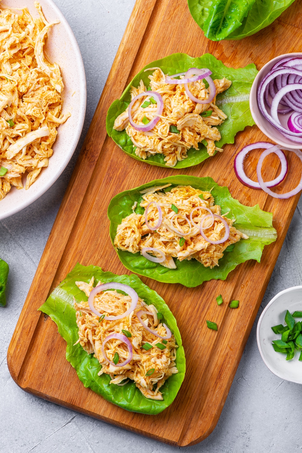 Buffalo chicken lettuce wraps on a cutting board.