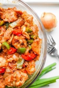 A bowl of BBQ chicken and vegetables.