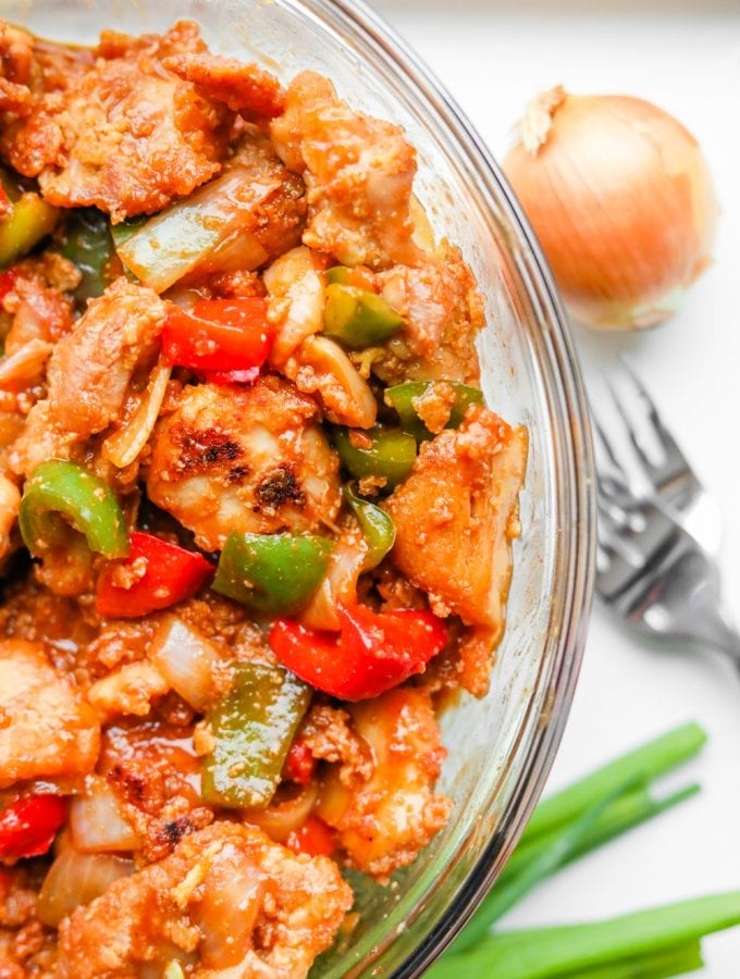 A bowl of BBQ chicken and vegetables.