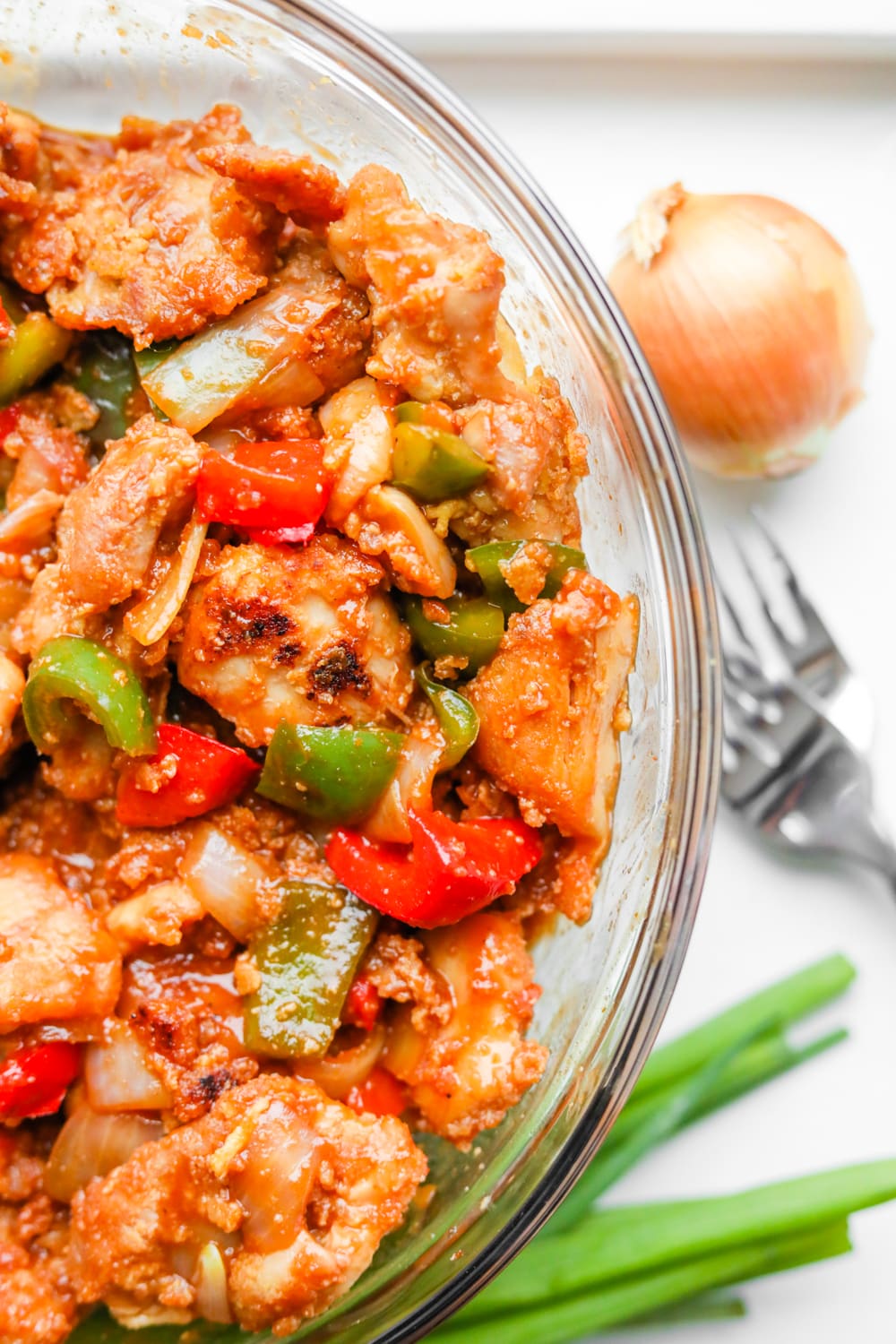 A bowl of BBQ chicken and vegetables.