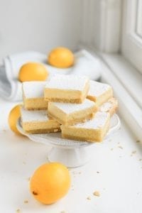 A stack of keto lemon bars on a serving plate.