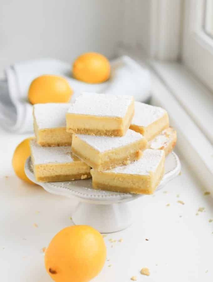 A stack of keto lemon bars on a serving plate.