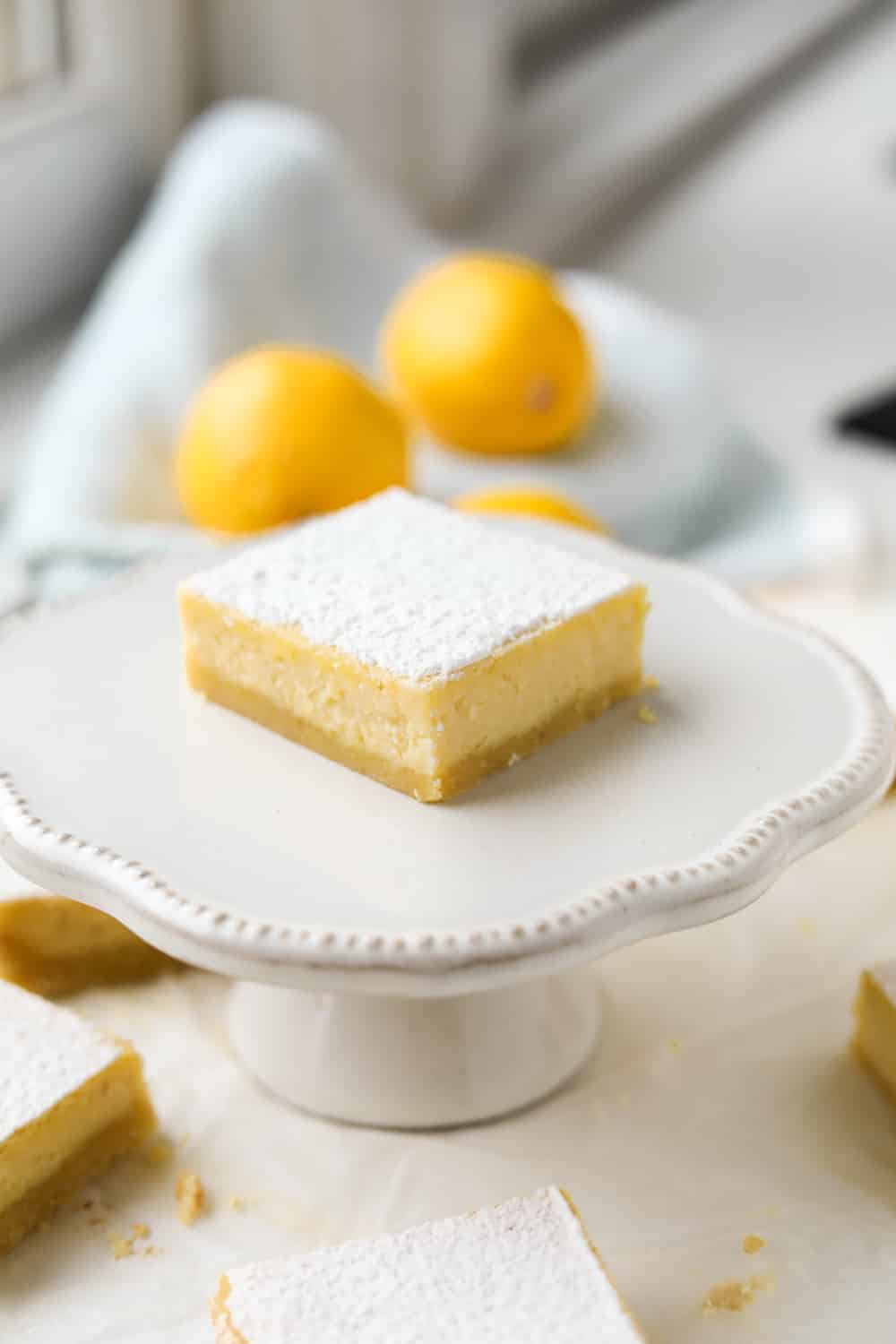 A lemon bar on a small serving dish.