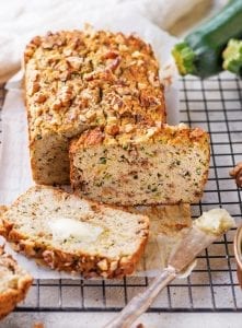 Zucchini bread cut into slices on a drying rack.