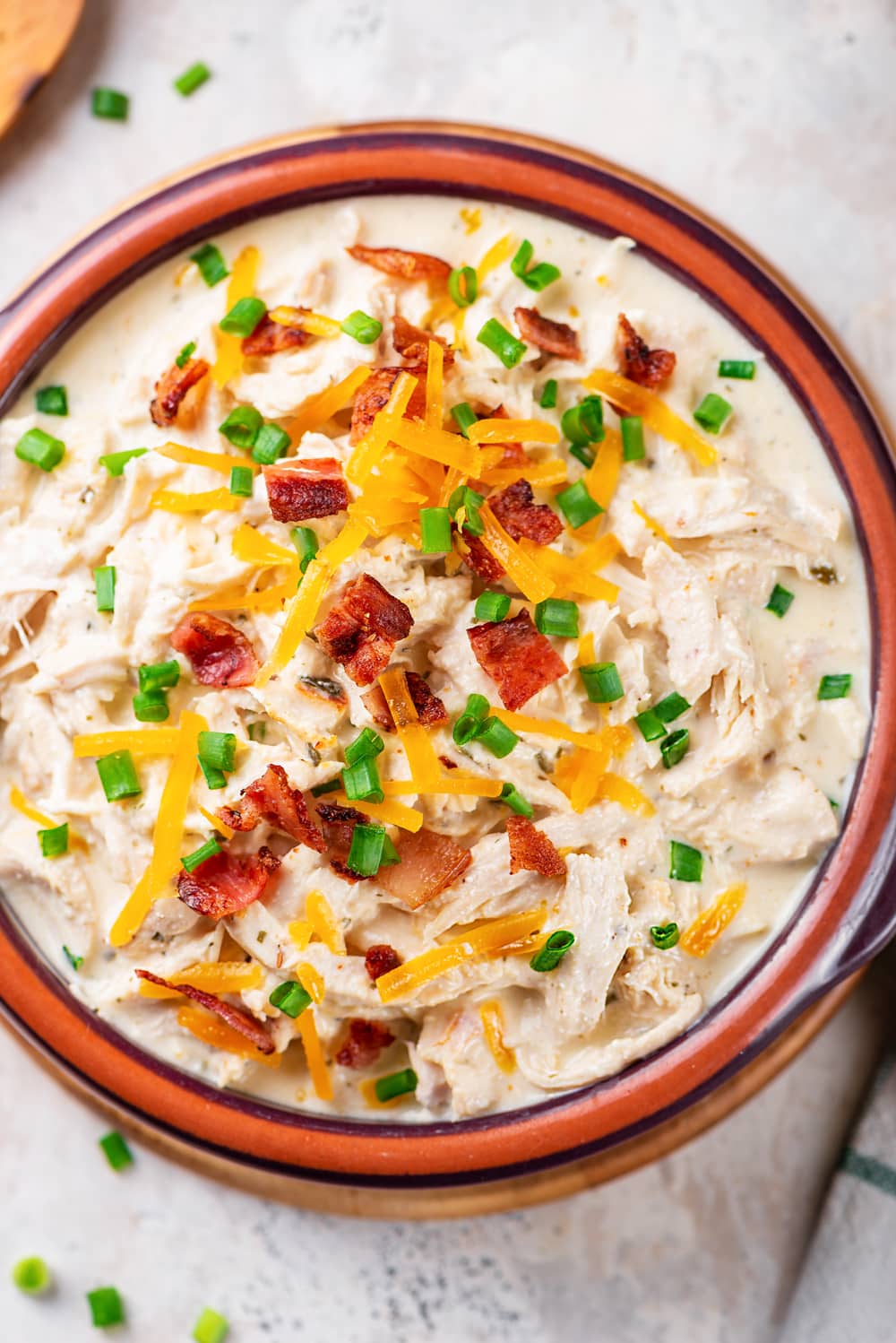 Crack chicken topped with green onions, bacon, and cheese.